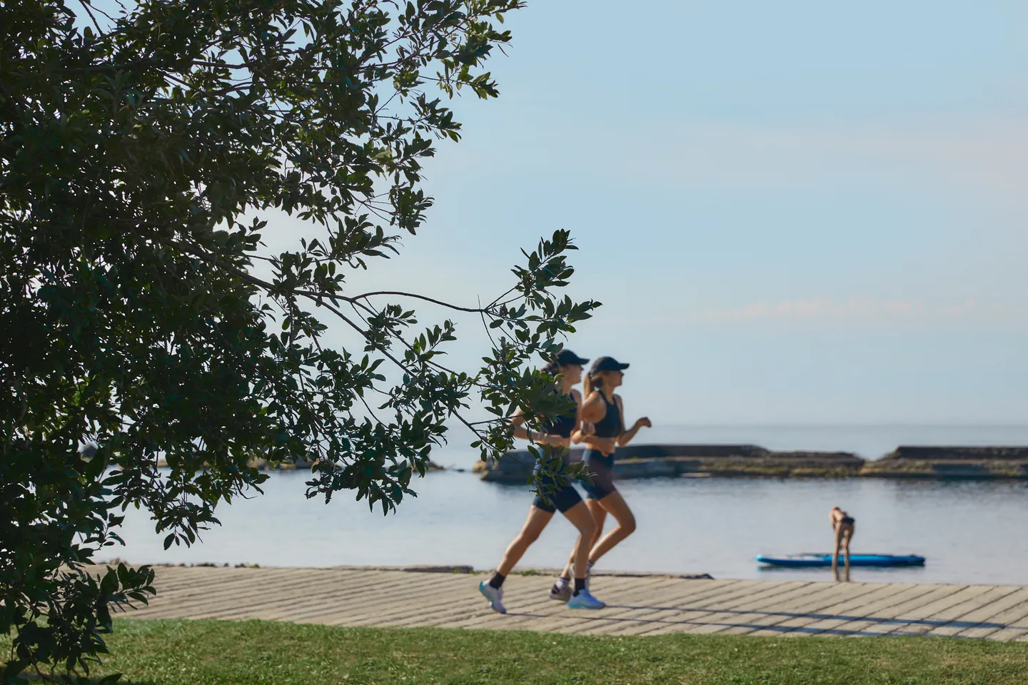 Runners on the waterfront path beside Lake Ontario